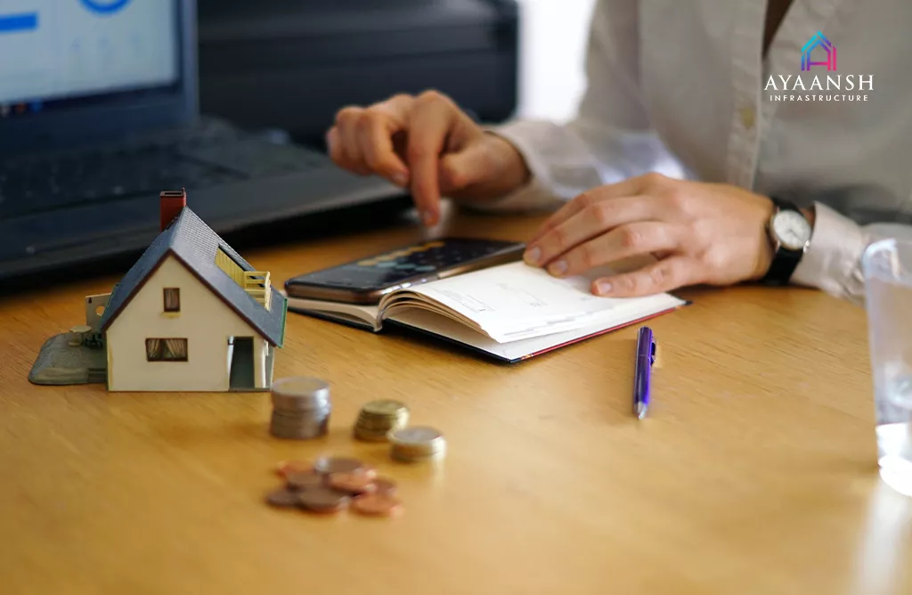  Budget Planning for Buying Villas in Vizag with a Calculator and a House Model for Smart Property Investment.