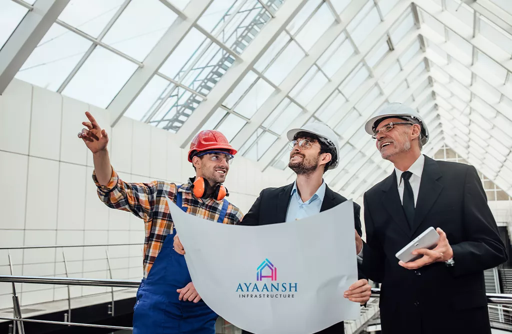 Engineers Reviewing Building Plans Inside a Bright Glass Atrium